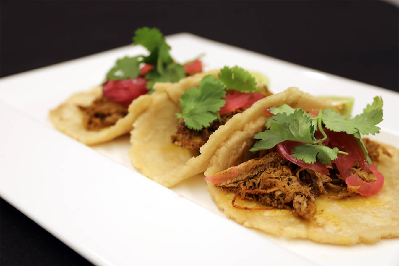 Barbacoa tacos plated