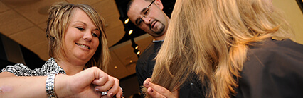 Cosmetology student and instructor cutting hair