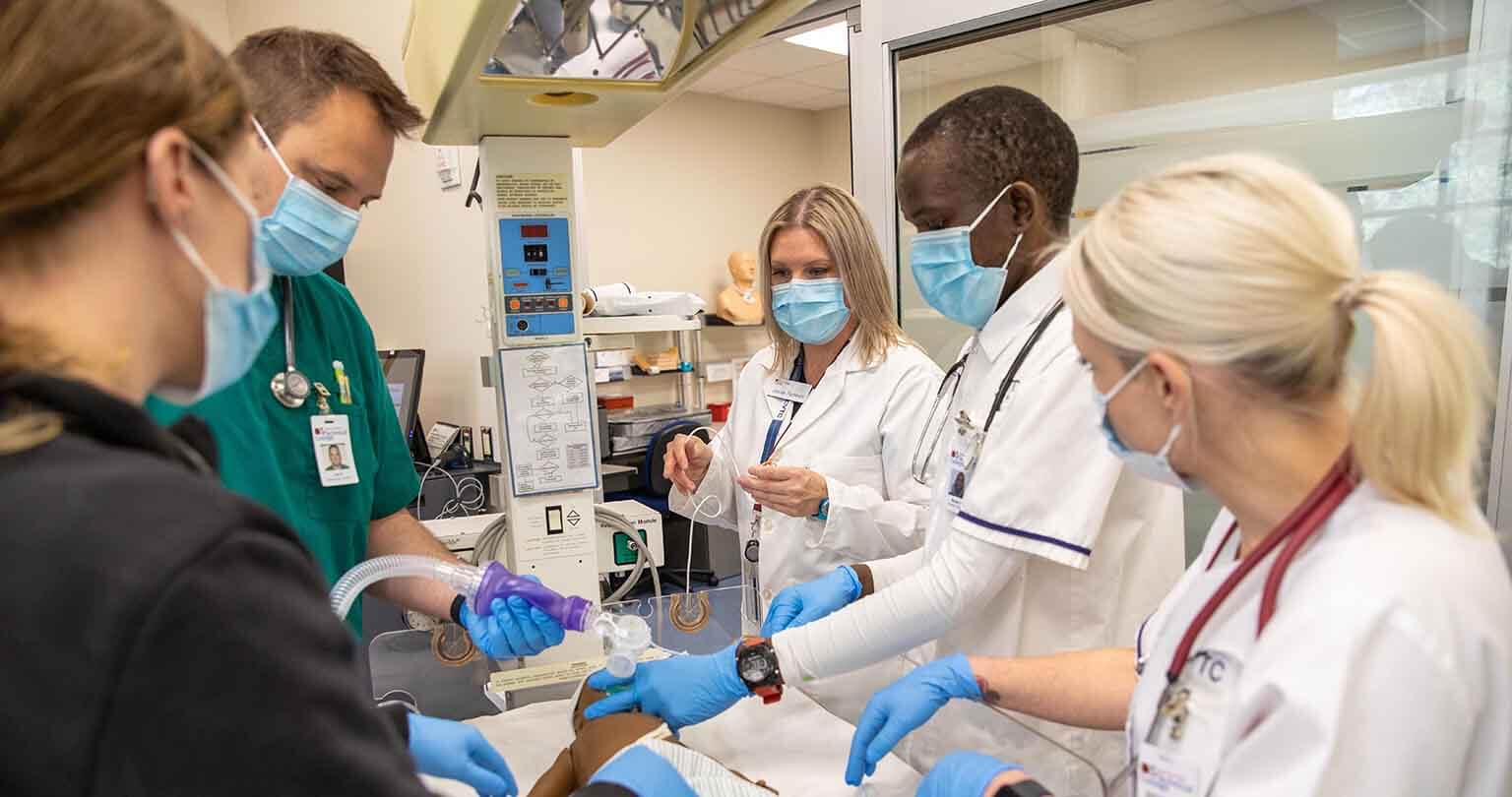 Five students working on a simulated medical procedure in the CVTC Clinical Simulation Center.