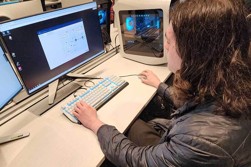 Close-up of male student working on a computer screen