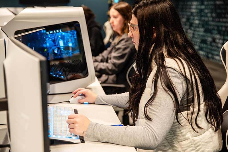 A side view of female students working on computers