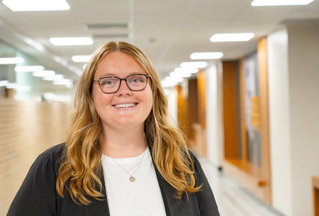 College advisor standing in lighted hallway