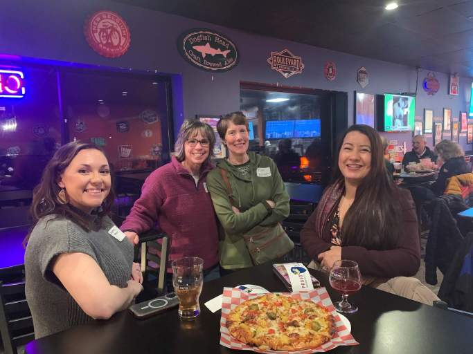 Alumni gathers around a table