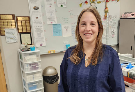 Non-traditional college woman in blue top in medical lab