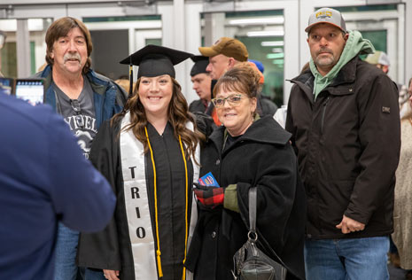 female graduate with family