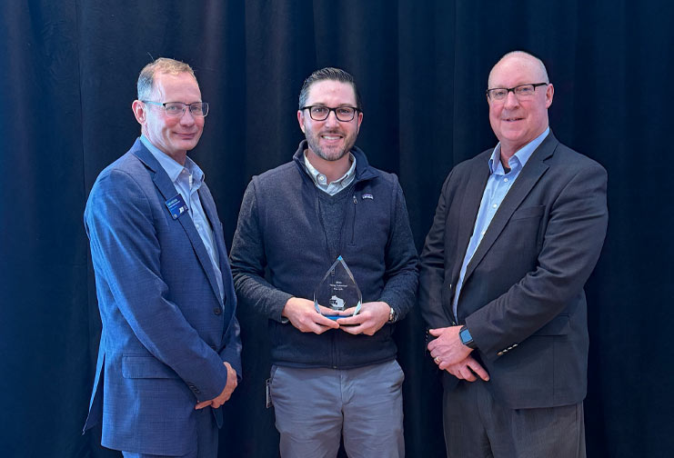 Three men at award ceremony